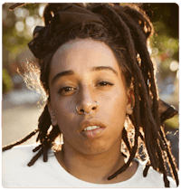 a young woman with dreadlocks and piercings