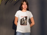 a woman wearing a white t - shirt with an image of a skeleton