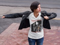 a woman wearing a leather jacket and a t - shirt