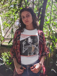 a woman wearing a t - shirt with a picture of a skeleton