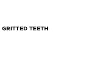 a black and white image of the word gritted teeth