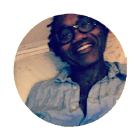 a man with glasses smiling in a circle